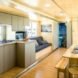 A living room and kitchen with a couch and benches.