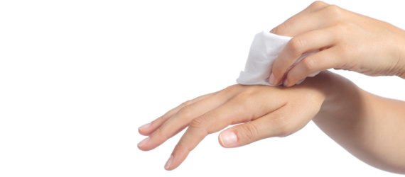 Hands of a woman cleaning with a baby wipe isolated on a white background