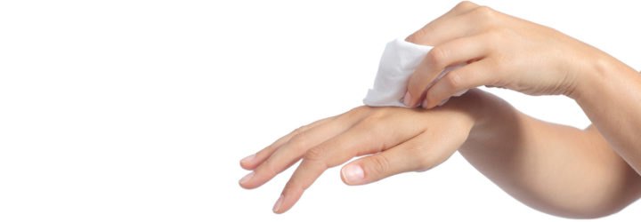 Hands of a woman cleaning with a baby wipe isolated on a white background
