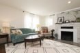 white-walled living room with green sofa and coffee table
