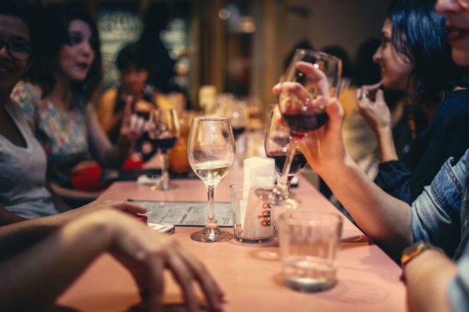 people at a restaurant drinking wine