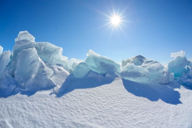 Winter Baikal lake landscape with Sun on blue sky
