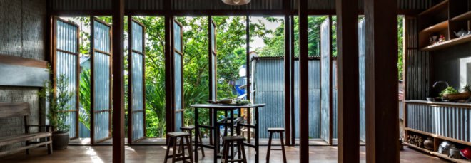 a dining table next to various open doorrs