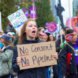 Woman holds sign that says 