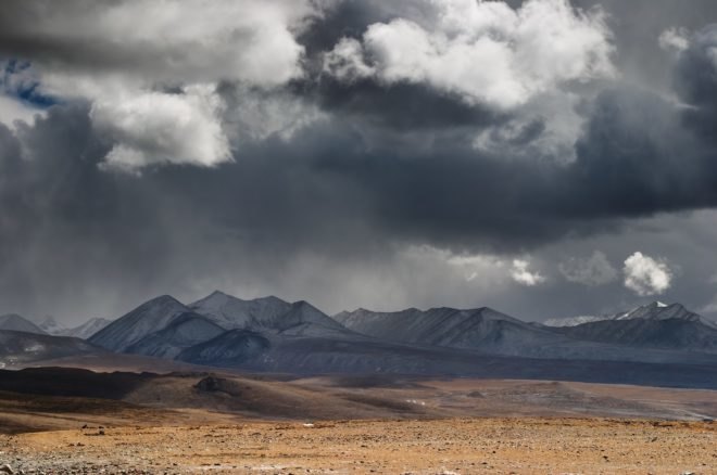 Clouds gather over the mountains and plains of the Tibetan Plateau
