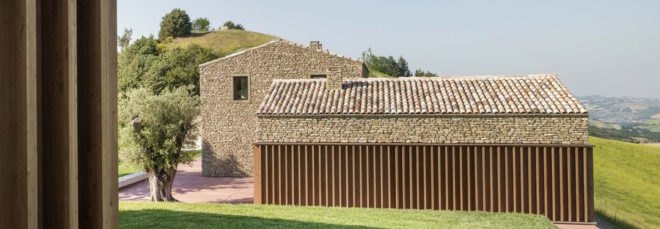 modern home with stone exterior and green yard