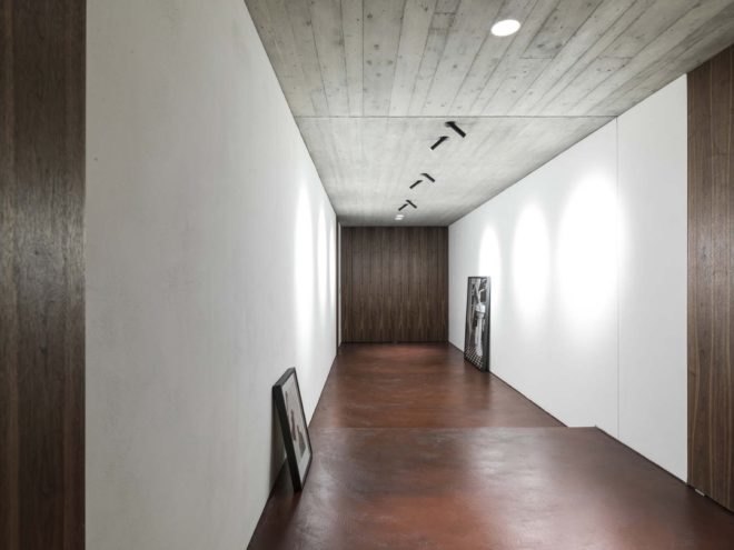 hallway with walnut flooring and white walls