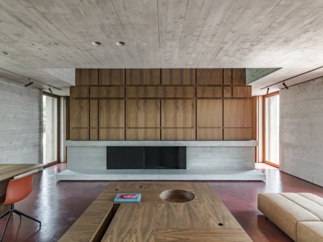 living room with fireplace and wood paneling