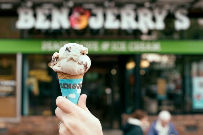 A hand holding a Ben & Jerry's ice cream cone