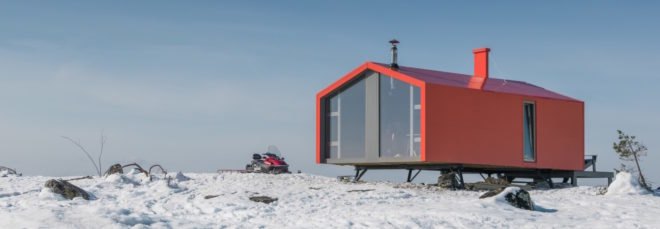 Red cabin on snowy landscape