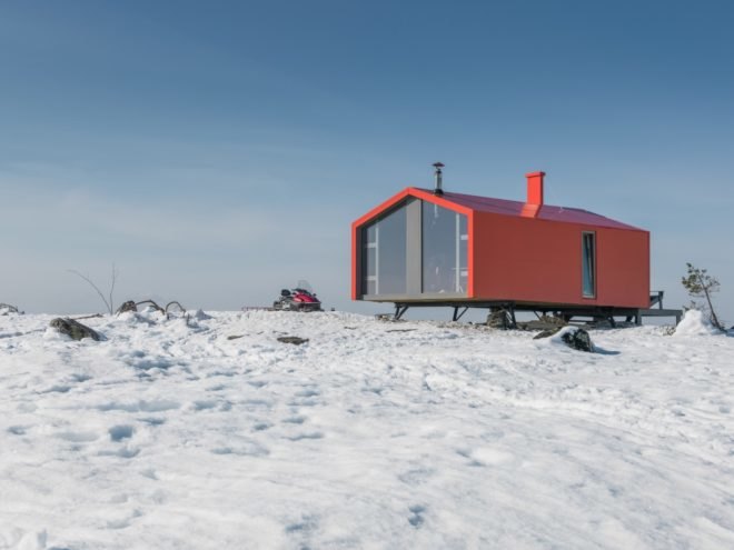 Red cabin on snowy landscape