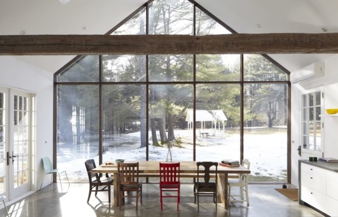 full height glazed wall with dining table sitting in front of it