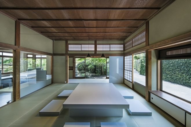traditional japanese room with long rectangular table and flat floor seating