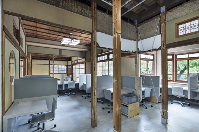 office area with several cubicles and rolling chairs