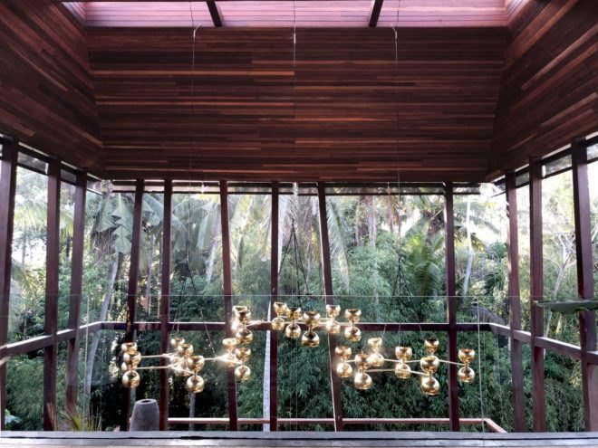 metal chandelier hanging from dark wood ceiling