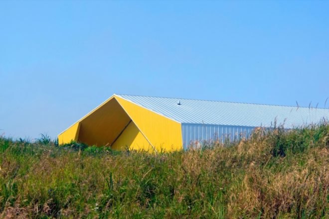 Exterior of cultural center with bright yellow facade