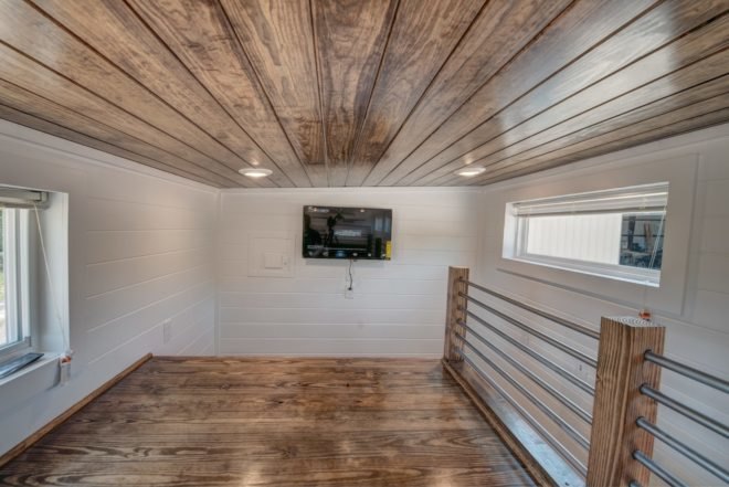 loft space with wooden ceiling and flooring