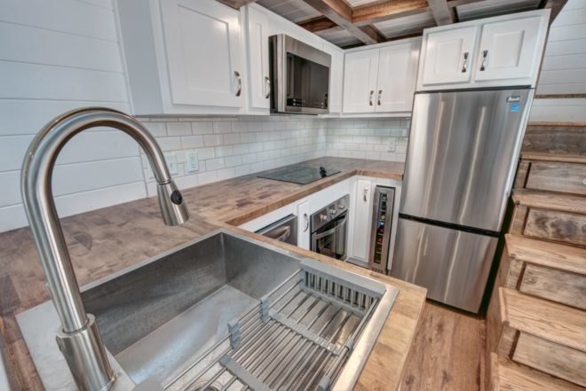 stainless steel sink with wooden countertop