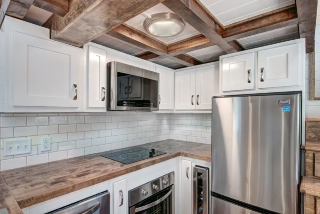 kitchen area with all white cupboards and wooden accents