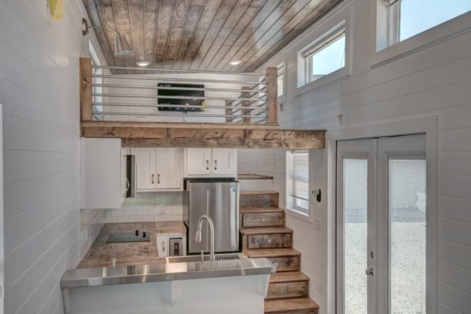 living room with sleeping loft above