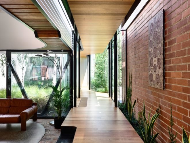 hallway with brick wall and plants