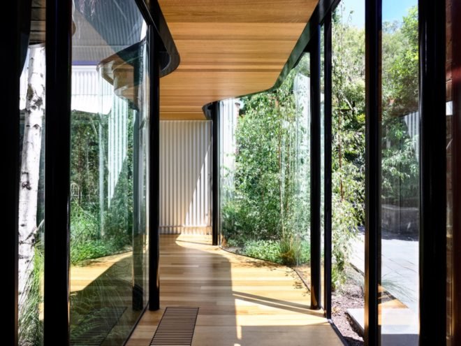Corridor with wood floors and glass walls