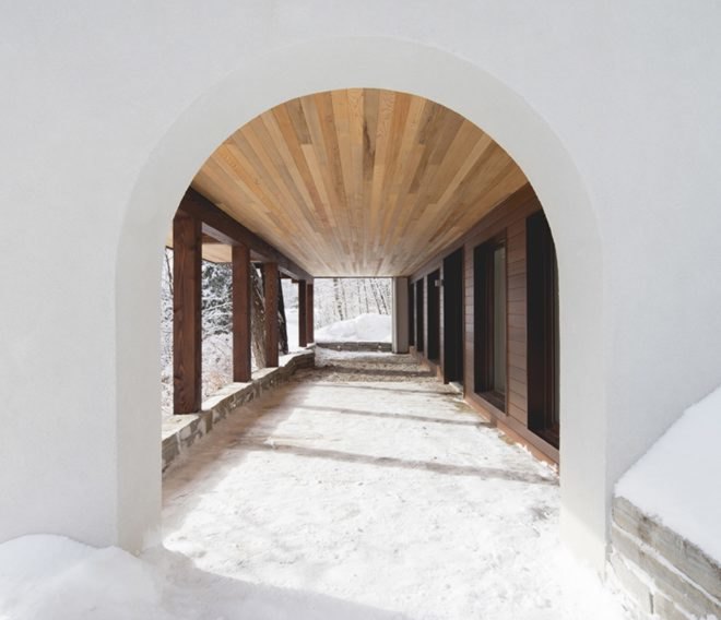 white arched doorway with snow on the ground