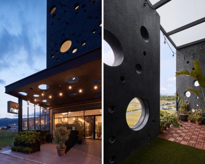 black home with several round windows of varying sizes
