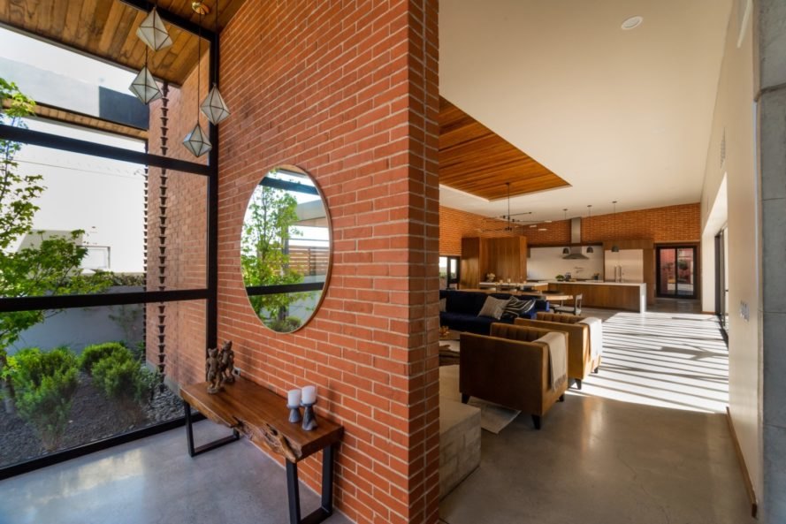 a brick separation wall with large round mirror