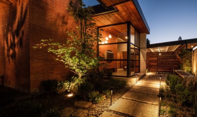 a walkway leading up to an all glass door