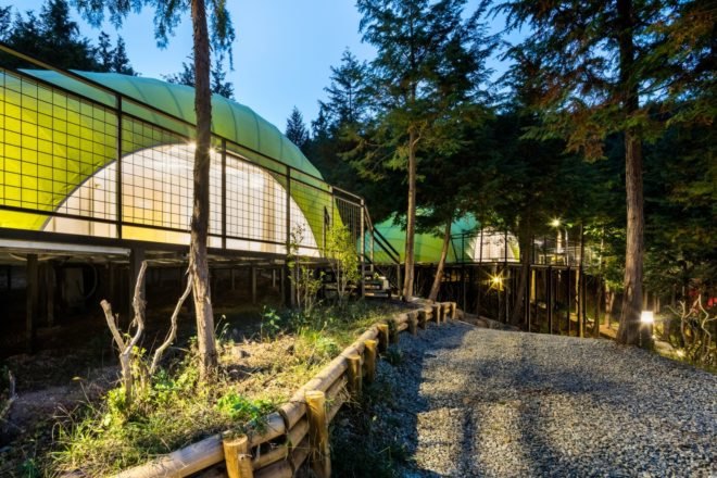 a walking path in front of a green building
