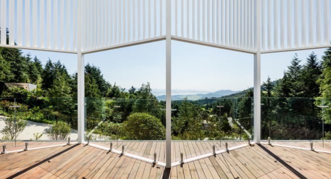 the view from a glass window looking out over a forest