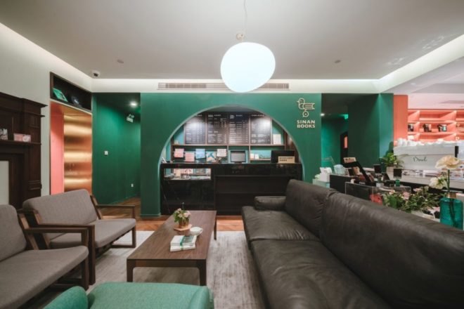 cafe with green walls and dark furniture in bookstore