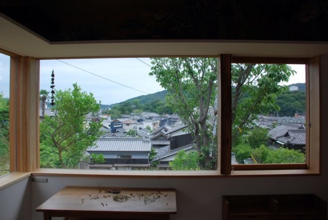 a large window looking out over rooftops