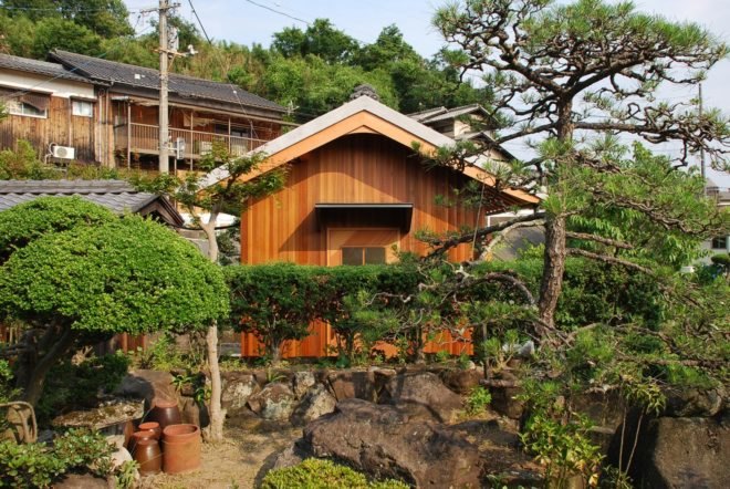 wooden hut surrounded by greenery