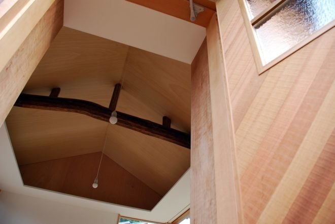 an natural log beam hanging from a ceiling