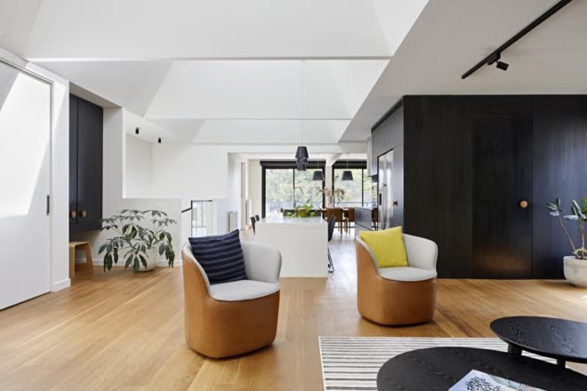 living room with tan and white chairs and dark wood tabled