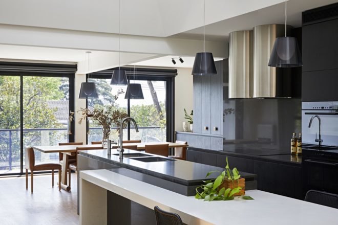 kitchen with dark cabinetry and dark pendant lighting