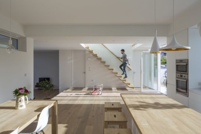 view of wooden staircase from kitchen