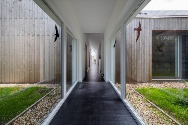 corridor with glazed walls and dark flooring