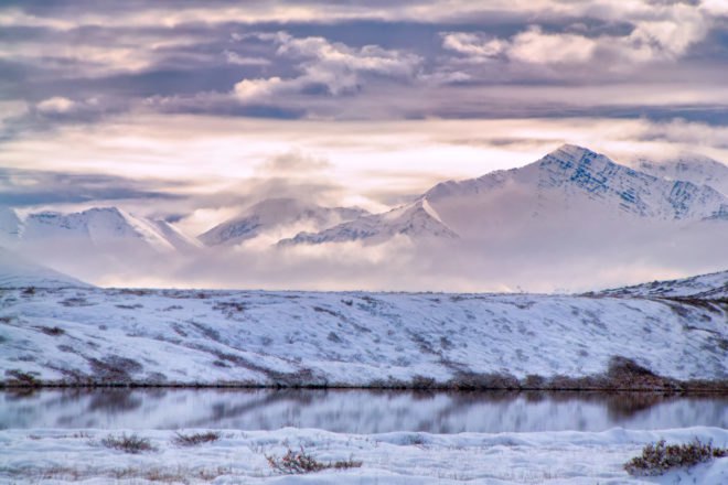 Clouds around snow-covered mountains
