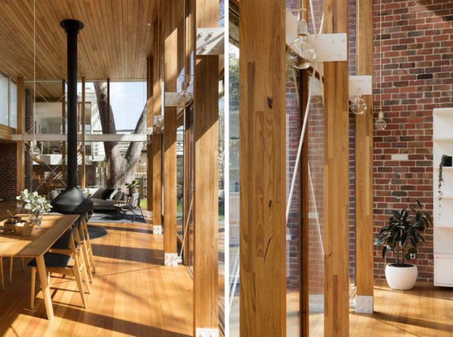 On the left, wooden dining table and chairs near glass wall. On the right, wood floor to ceiling beams and modern lights