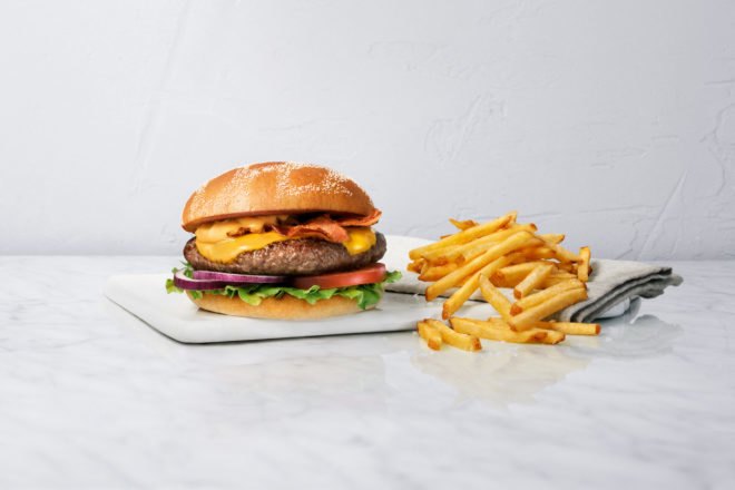 A MAX burger and fries on white background