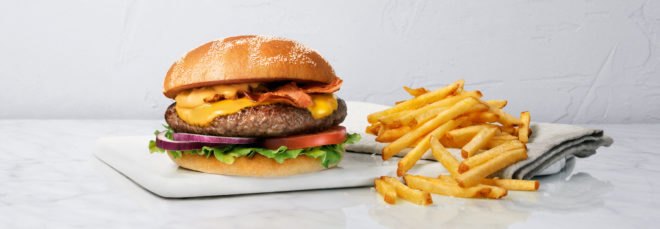 A MAX burger and fries on white background