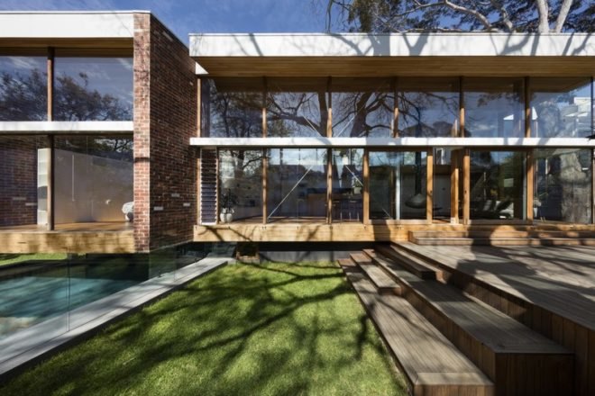 Wood and brick exterior of home with large full-height windows