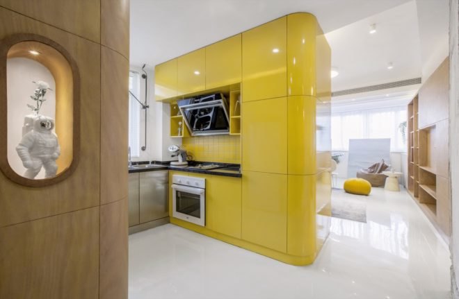yellow kitchen cube with timber entertainment center in background