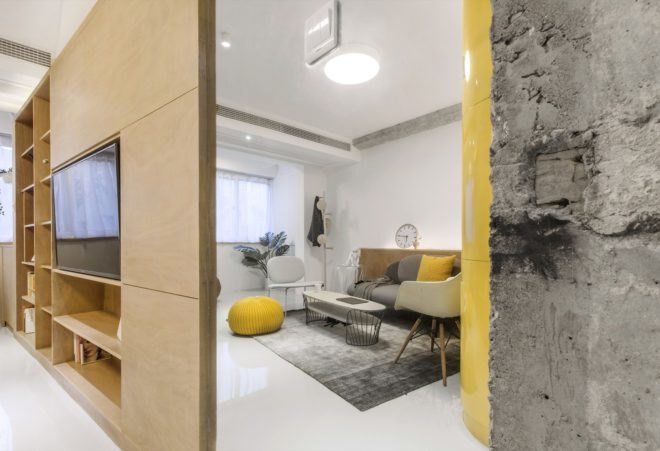 the living area with gray couch and rug and a couple of white chairs