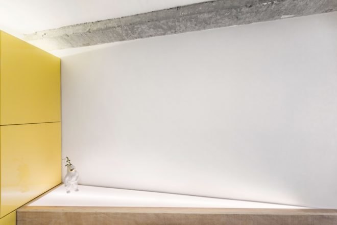 triangle-shaped light box behind the couch