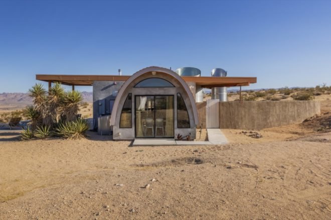 front of house with curved roof above entrance