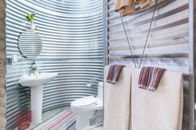 bathroom inside a rounded corrugated metal room